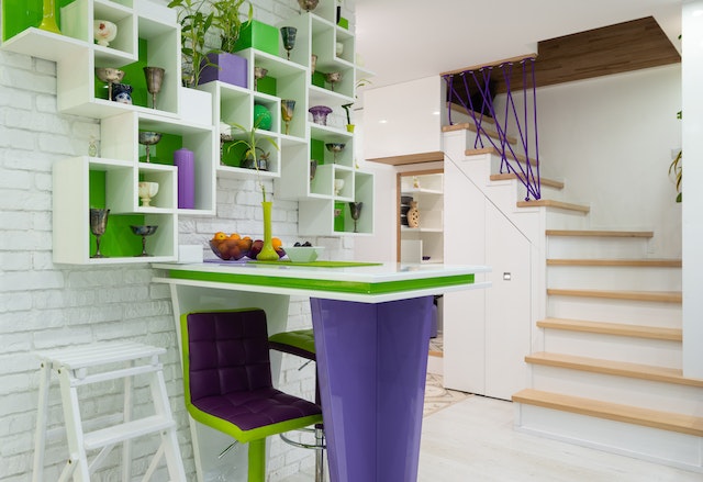 shelves-with-different-decorations-hanging-on-wall-above-counter-in-modern-house